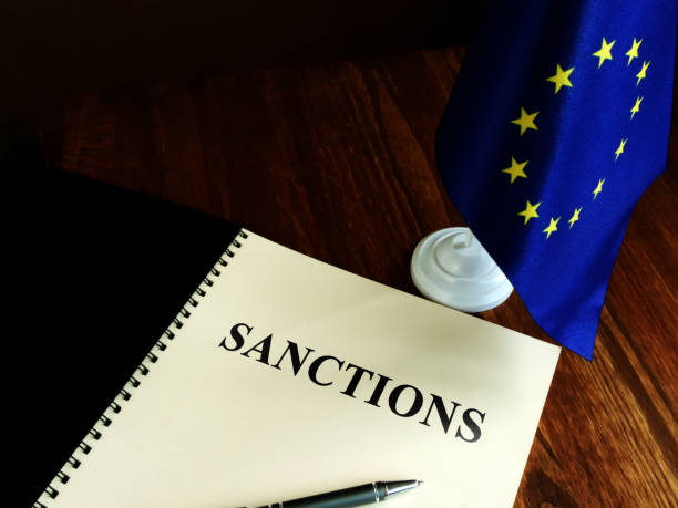Sanctions list and EU flag on the desk. ВТБ Банк (Казахстан) попал под санкции ЕС — Нацбанк заявил об отсутствии рисков для финансовой системы